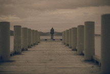 man standing at the end of a dock 