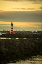 red and white lighthouse on a shore 