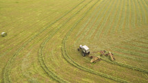 A field being plowed with a combine tractor.