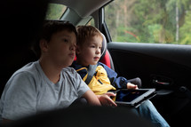 Two boys in the car with tablet PC