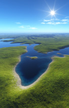 aerial view over island grassland and water 