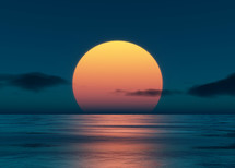 big orange sun over the ocean at sunset 