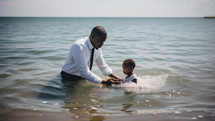 Baptism. A black Pastor baptize a little black kid in the water