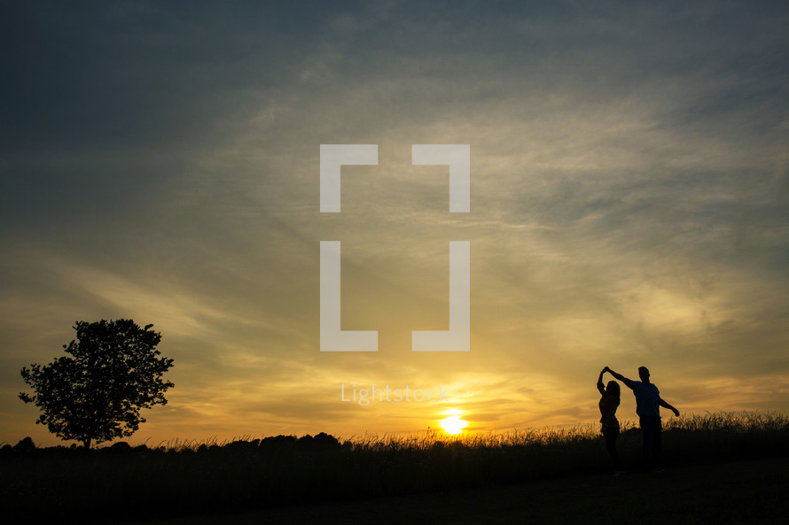 silhouette of a couple dancing outdoors 