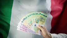 Italian flag background. Woman with cash money euros. 