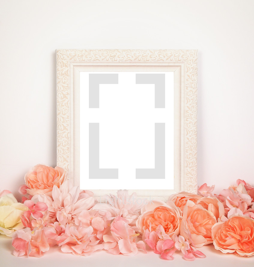 white frame and peach and peace flowers 