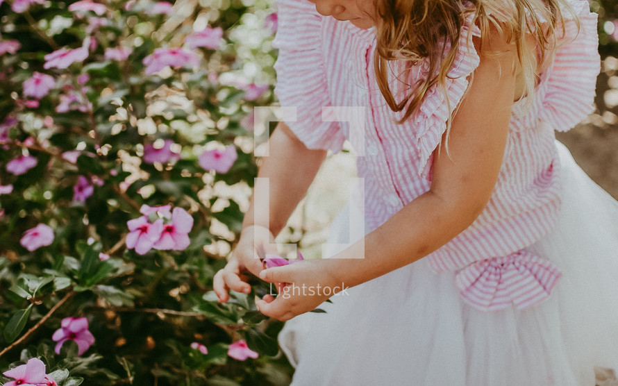 little girl picking flowers 