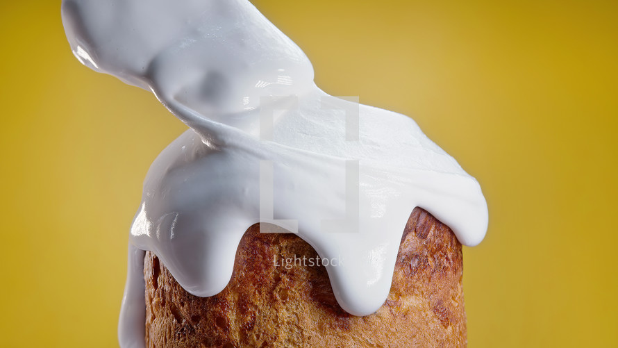 Close-up of Easter cake, decoration with white glaze, traditional bakery. Spring christian religious holiday. Delicious homemade festive sweets. Yellow background. High quality
