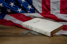 Holy Bible, American flag, and military dog tags