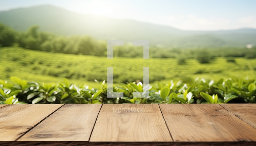 Wooden table top on green tea plantation background. For product display