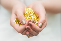 hands full of gold glitter