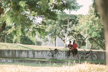 a couple sitting on a wall at a park 