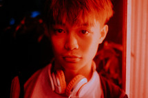 teen boy with headphones around his neck 