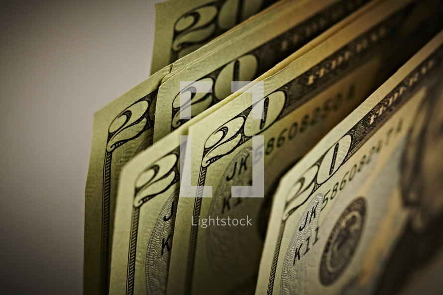 A fanned out view of twenty dollar bills.