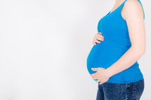 Pregnant woman holding her stomach.