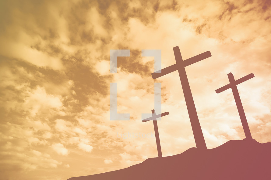 three crosses on a mount at sunrise 
