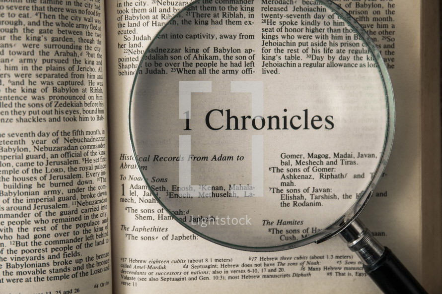 magnifying glass over Bible - 1 Chronicles 