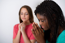 teen girls praying hands 