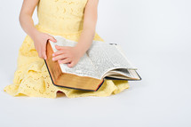 Open Bible in a little girl's lap.