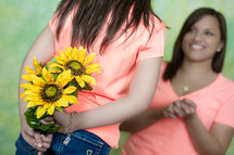 daughter handing her mother flowers