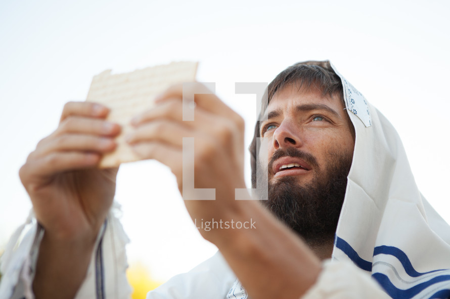 Levitical Priest Bible Character Breaking Bread from the Torah offering Communion representing the bread of life while wearing a prayer shawl.
Johavah Yahweh blessing the bread that came down from heaven like the manna in the wilderness