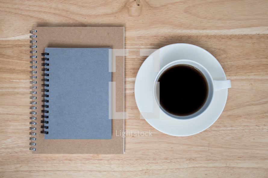 spiral notebooks and coffee cup 