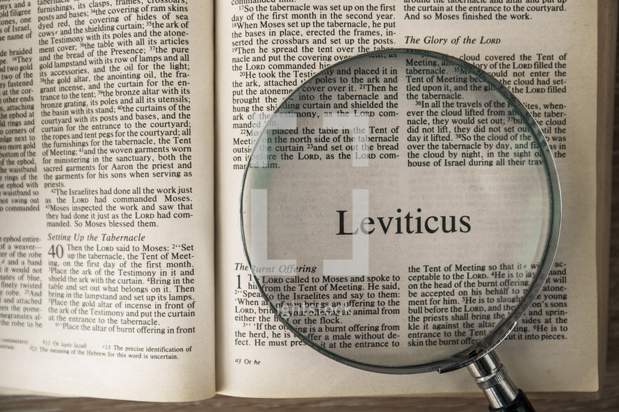 magnifying glass over Bible - Leviticus 