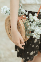 flowers in a straw purse 
