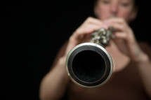 Woman playing an oboe.