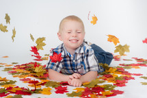 boy child and fall leaves 