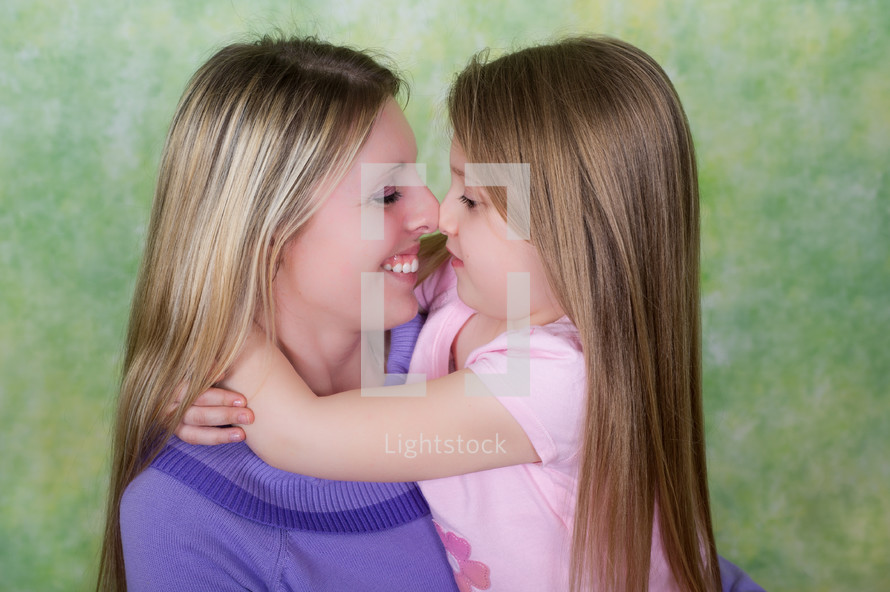 mother and daughter rubbing noses