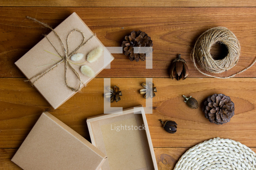 brown gift box and pine cones 
