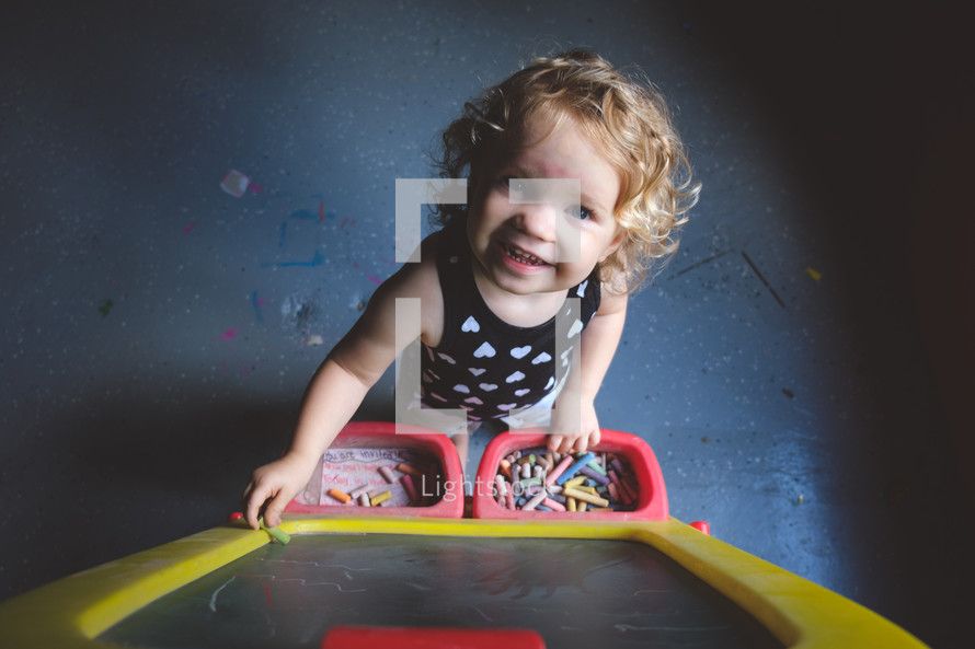 happy toddler with chalk 