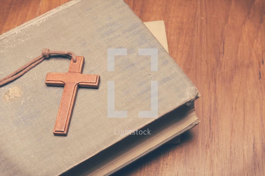 a wooden cross on books