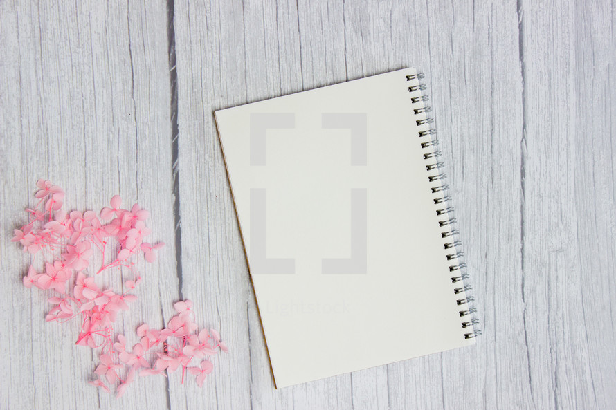 pink flowers and blank notebook 