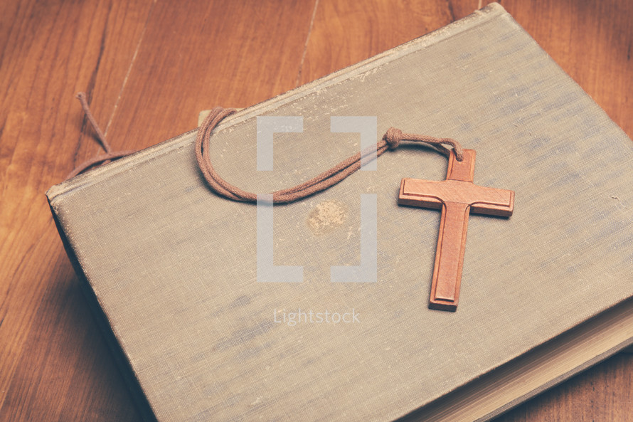 a wooden cross on a Bible 
