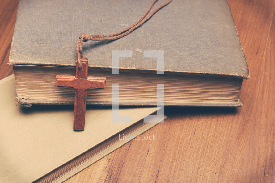 a wooden cross and books 