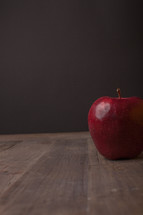 apple on a wood desk 