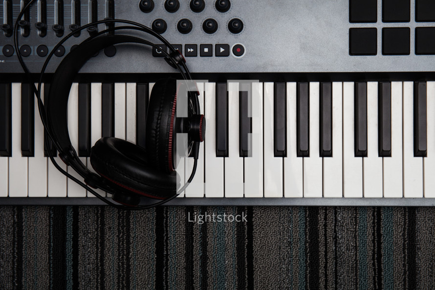 headphones on a  digital piano keyboard 