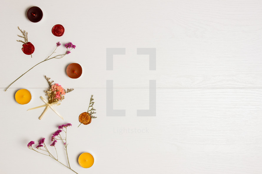 flowers and candles on a white background 