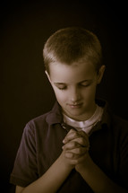 A boy child praying 