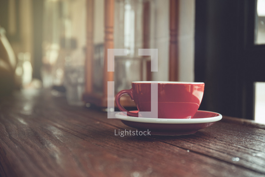 red mug on a wood table 
