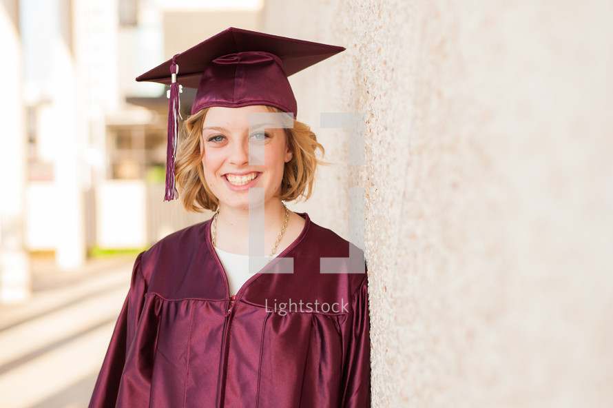 Smiling woman in a cap and gown.