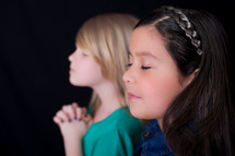 young girls with praying hands 