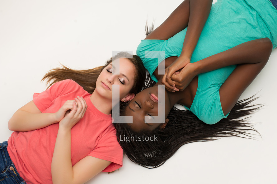 teen girl lying down in prayer 