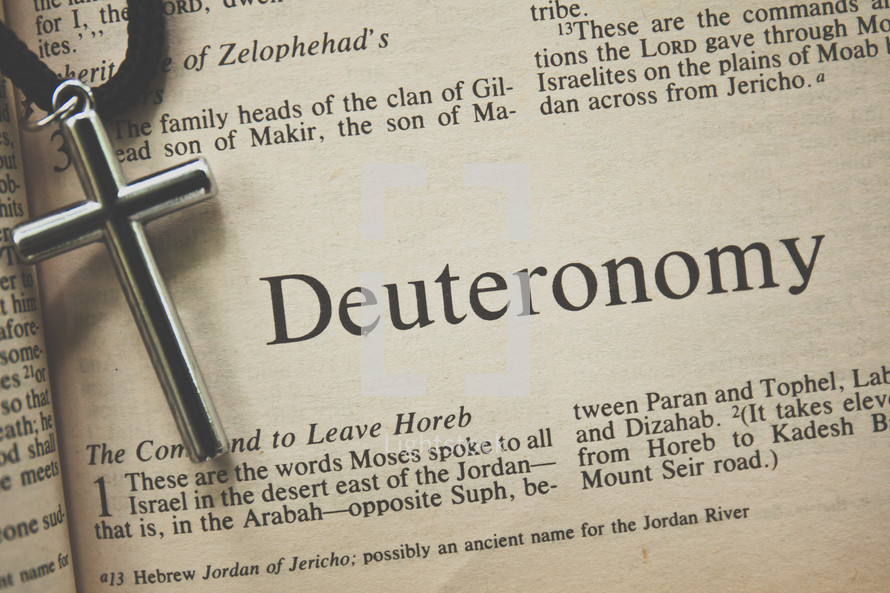 Deuteronomy and a cross necklace 