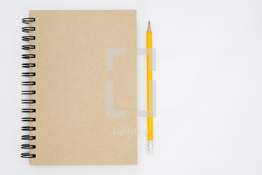 notebook and pencil on white background 