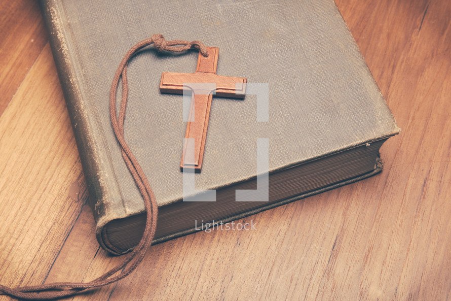 a wooden cross on a book 