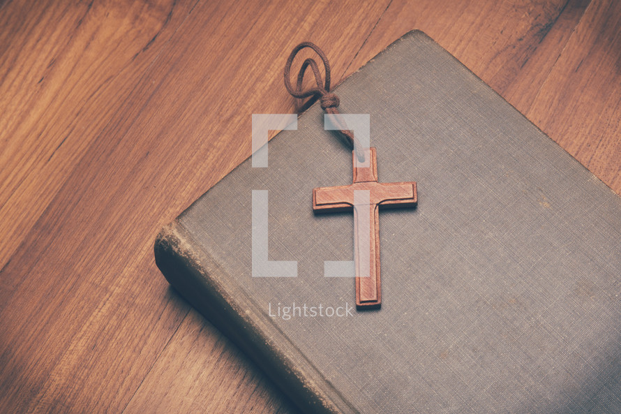 a wooden cross on a Bible 