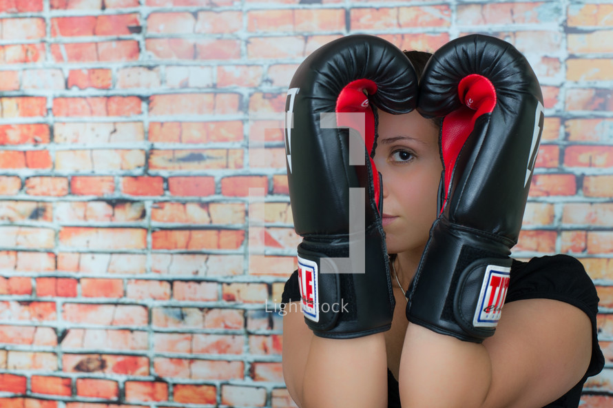 female boxer with her hands up 
